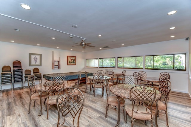 dining space featuring light wood-type flooring and ceiling fan