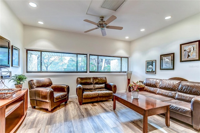 living room featuring light hardwood / wood-style floors and ceiling fan