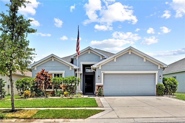 view of front of house with a front yard and a garage