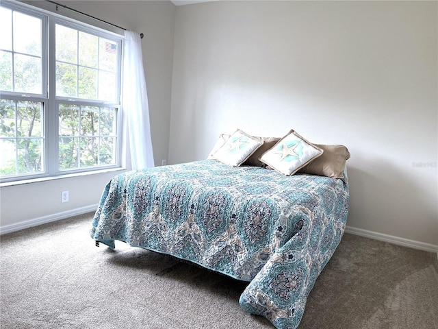 carpeted bedroom featuring baseboards