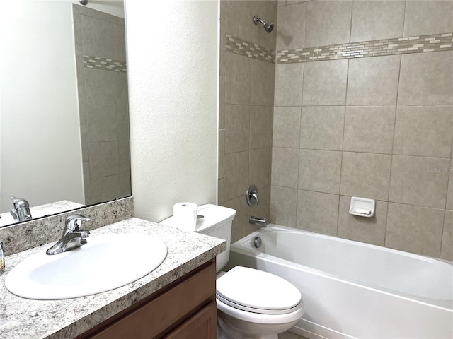 full bathroom with vanity, toilet, a textured wall, and shower / bath combination