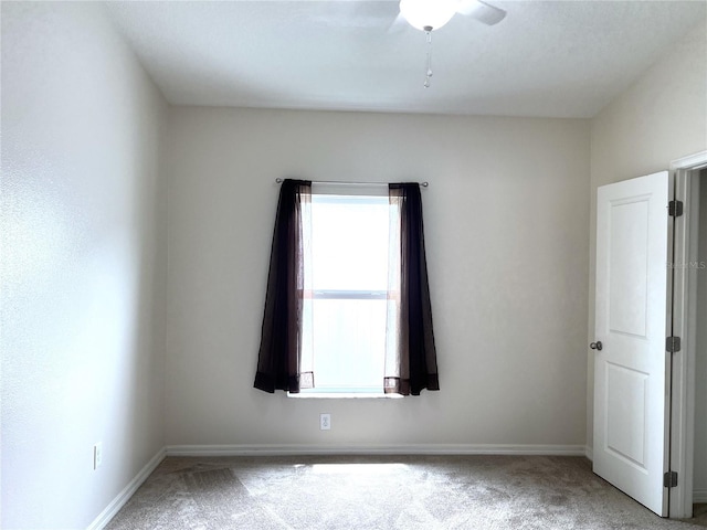 unfurnished room with baseboards and carpet floors