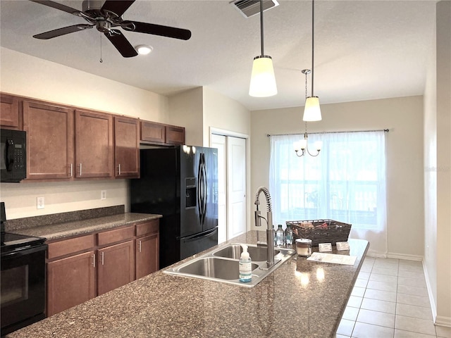 kitchen with light tile patterned floors, visible vents, a sink, black appliances, and decorative light fixtures