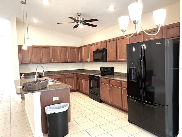 kitchen featuring light tile patterned flooring, a sink, black appliances, vaulted ceiling, and pendant lighting