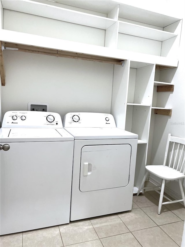 laundry area featuring light tile patterned floors, laundry area, and washer and dryer