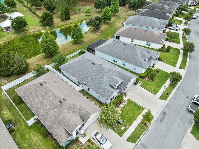 drone / aerial view with a residential view and a water view