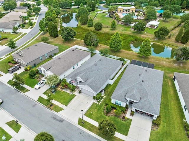 drone / aerial view featuring a water view and a residential view