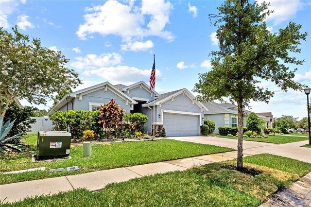 view of front facade featuring stucco siding, an attached garage, concrete driveway, and a front yard