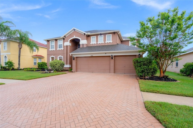 view of front of property featuring a front lawn and a garage