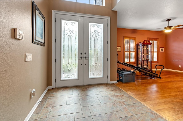 foyer with french doors, light hardwood / wood-style flooring, a wealth of natural light, and ceiling fan