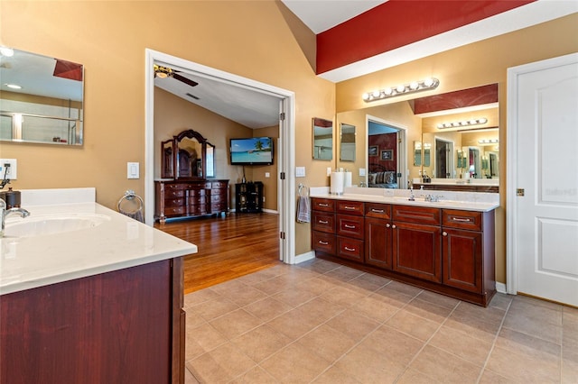 bathroom featuring hardwood / wood-style floors, vanity, ceiling fan, and lofted ceiling