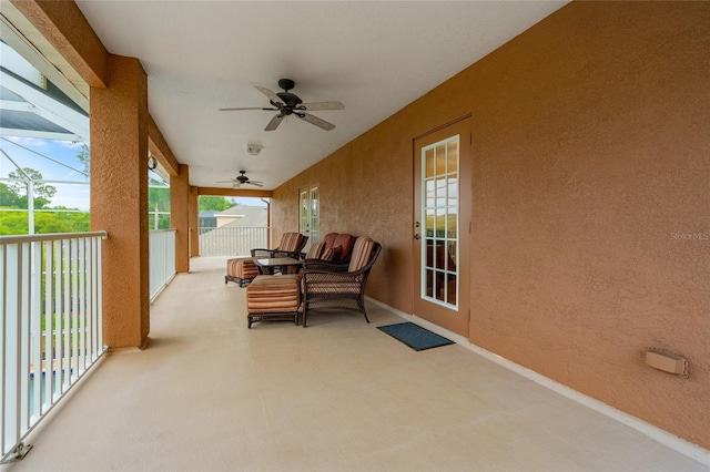 sunroom / solarium featuring ceiling fan