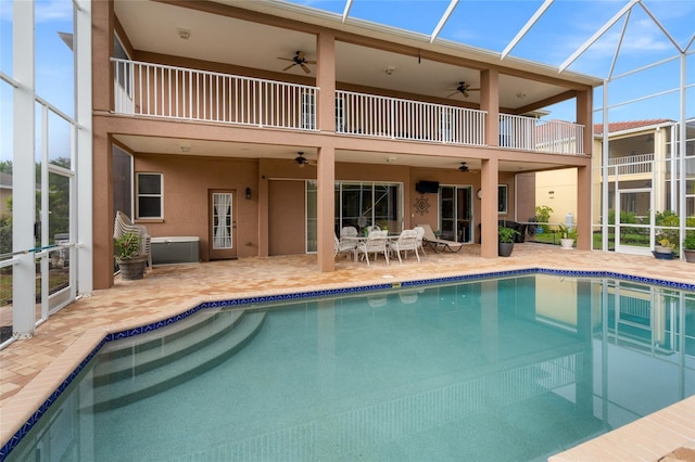 back of house featuring a patio, a balcony, and a lanai