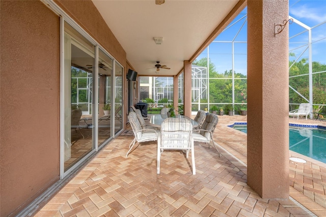 unfurnished sunroom featuring ceiling fan and a swimming pool