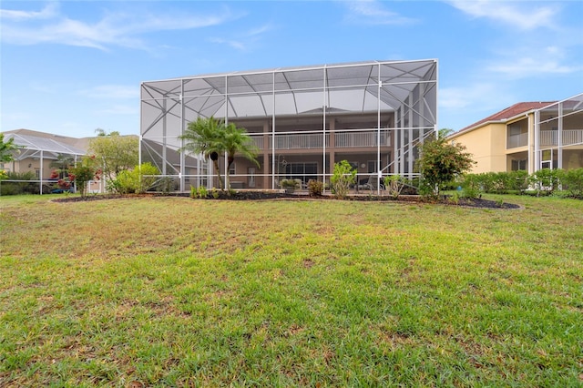 back of house with a lawn and a lanai