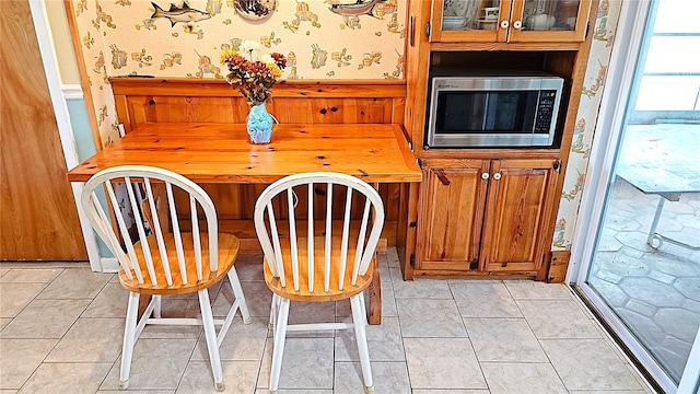 unfurnished dining area with light tile patterned floors