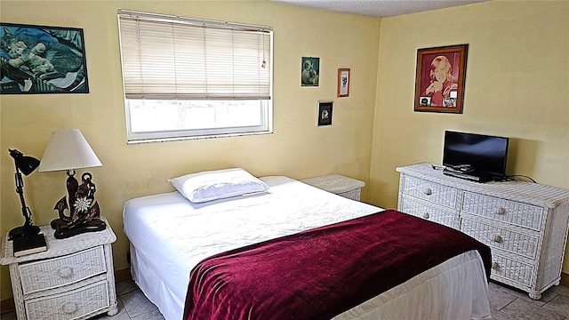 bedroom featuring light tile patterned flooring