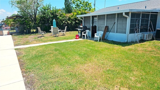 view of yard featuring central air condition unit and a sunroom