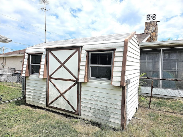 view of outbuilding featuring a lawn