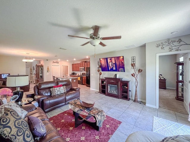 tiled living room featuring ceiling fan