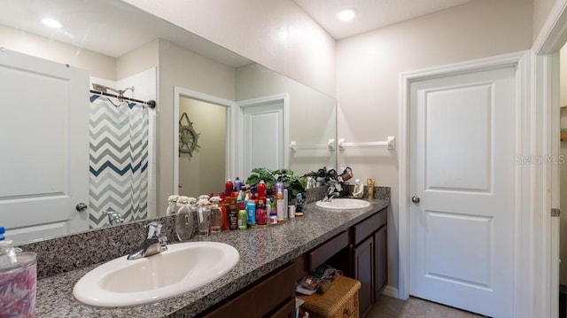 bathroom featuring a shower with shower curtain, vanity, and tile patterned floors