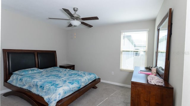 bedroom with ceiling fan and light carpet