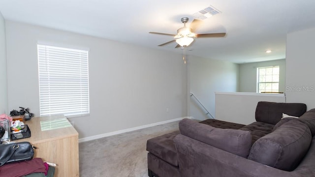 living room with ceiling fan and light colored carpet