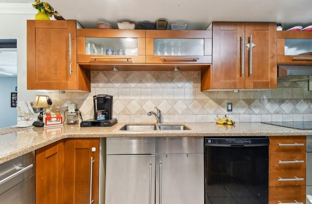 kitchen featuring black appliances, sink, tasteful backsplash, light stone counters, and extractor fan