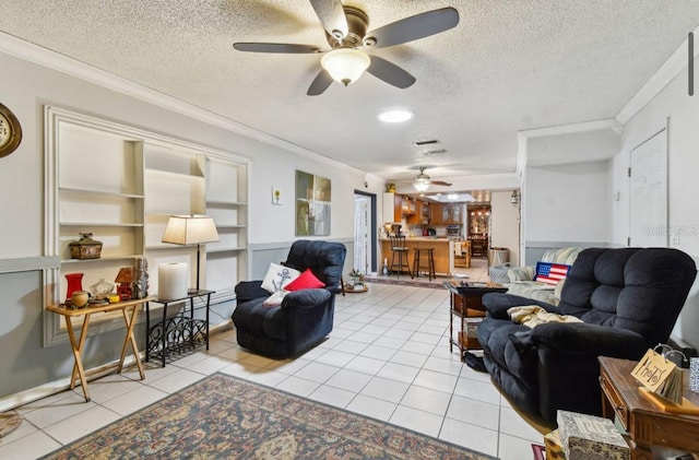 living room featuring light tile patterned floors, a textured ceiling, and ornamental molding