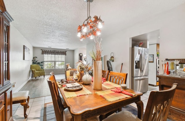 dining room with light tile patterned floors and a textured ceiling