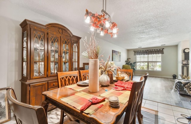 dining room with light tile patterned floors and a textured ceiling