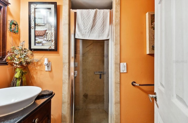 bathroom with vanity and a shower with shower door