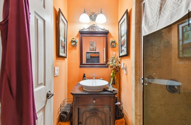 bathroom featuring vanity and an enclosed shower