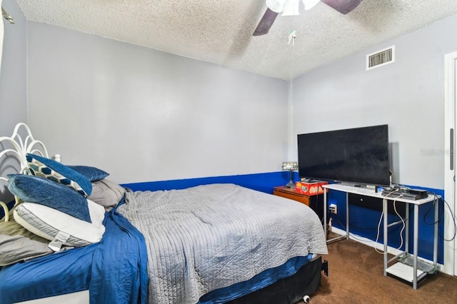 carpeted bedroom with a textured ceiling and ceiling fan