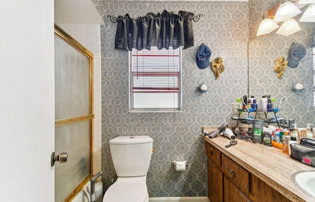 bathroom with vanity, toilet, and walk in shower