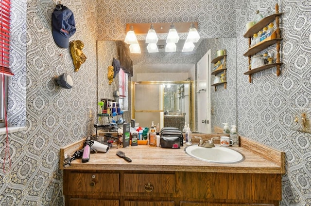 bathroom featuring vanity and a shower with shower door