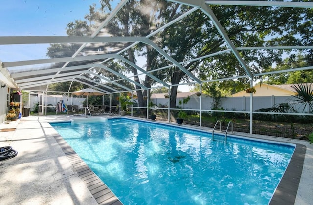 view of swimming pool featuring a patio area and a lanai