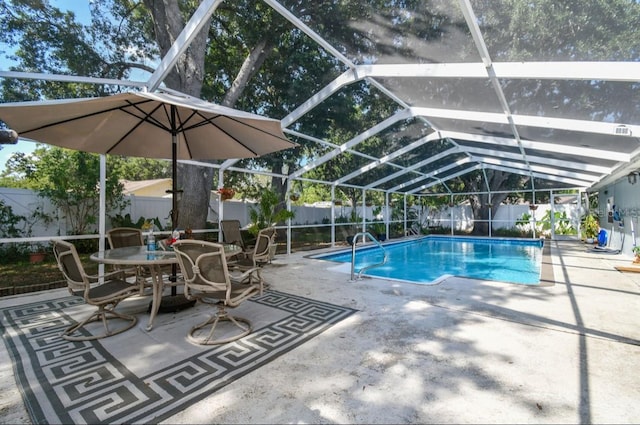 view of swimming pool with glass enclosure and a patio area