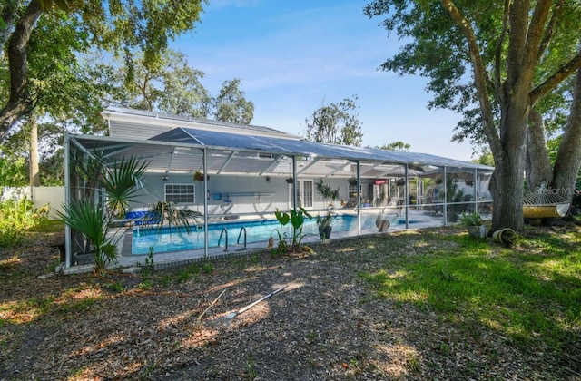 view of swimming pool featuring glass enclosure