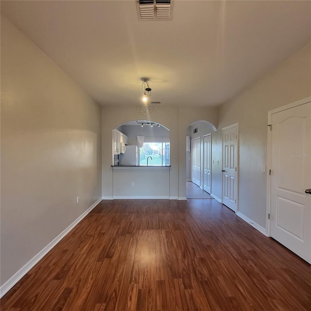 spare room with sink and dark hardwood / wood-style flooring