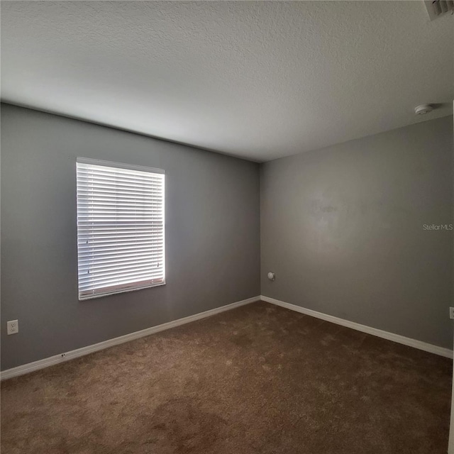 unfurnished room with dark carpet