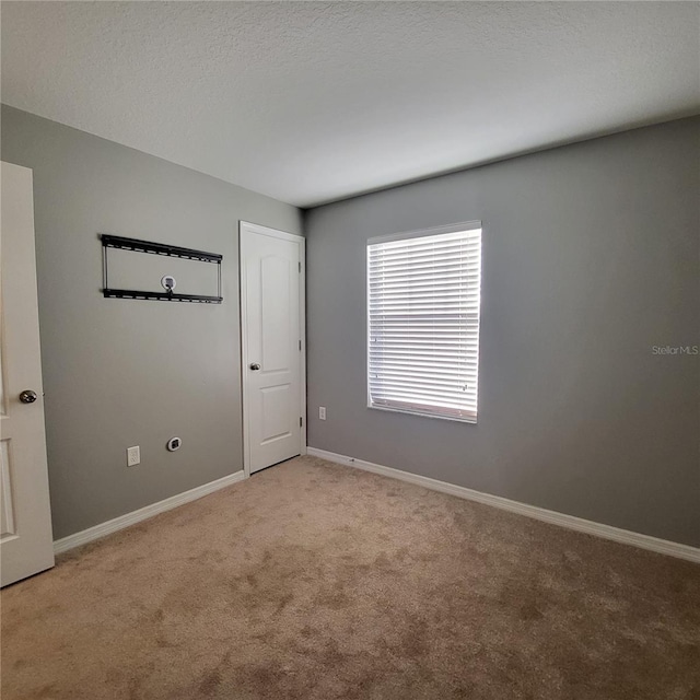 unfurnished room with light colored carpet