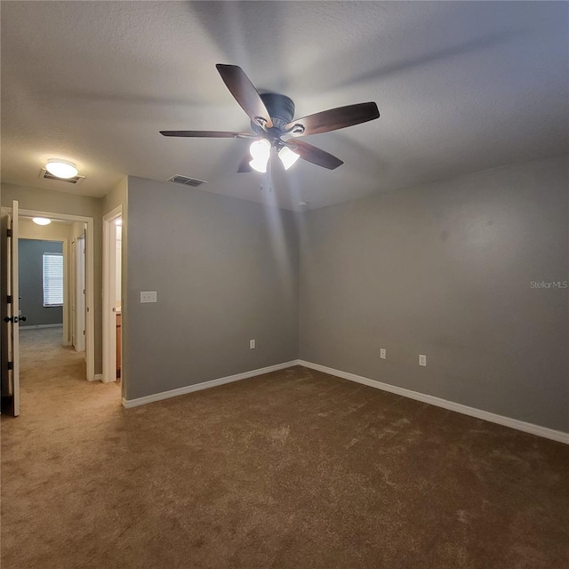 empty room featuring carpet floors and ceiling fan