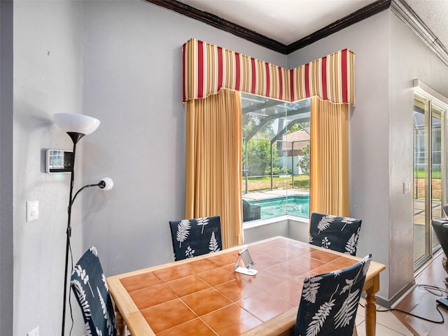 dining room with tile patterned flooring and crown molding