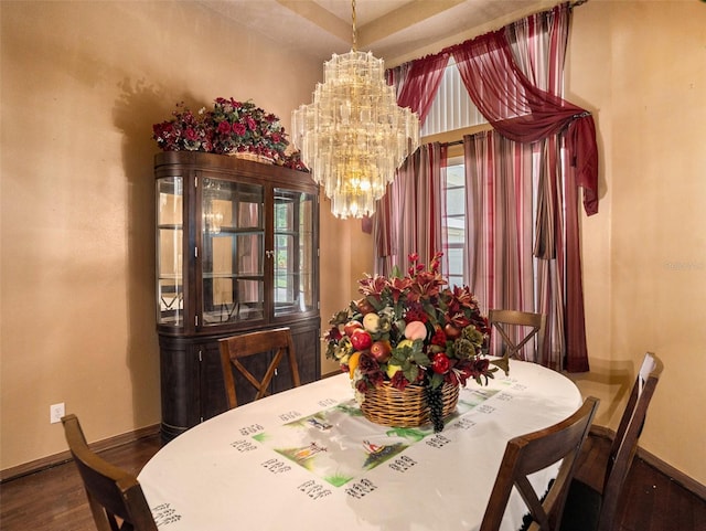 dining room with a notable chandelier and dark hardwood / wood-style floors