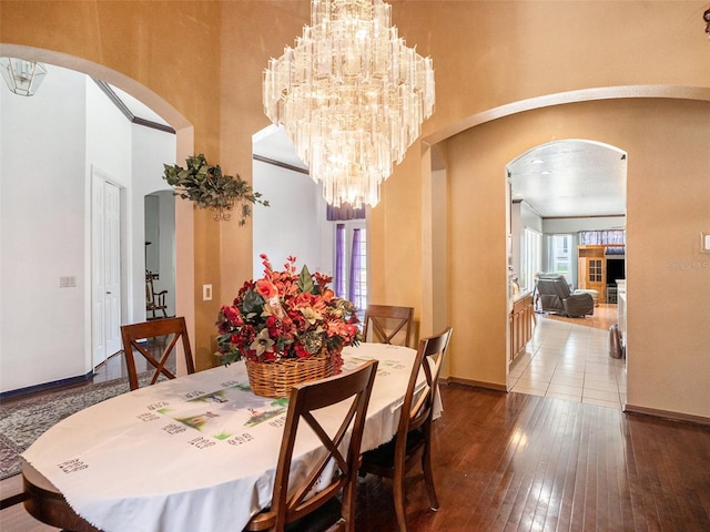 dining room with hardwood / wood-style floors and a chandelier