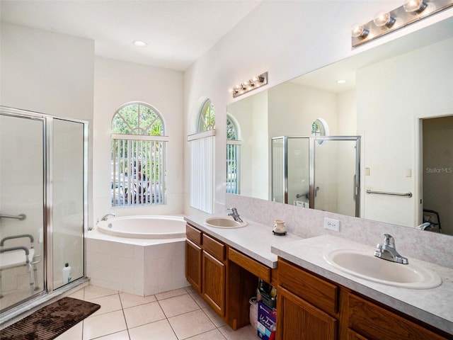 bathroom featuring tile patterned flooring, vanity, and shower with separate bathtub