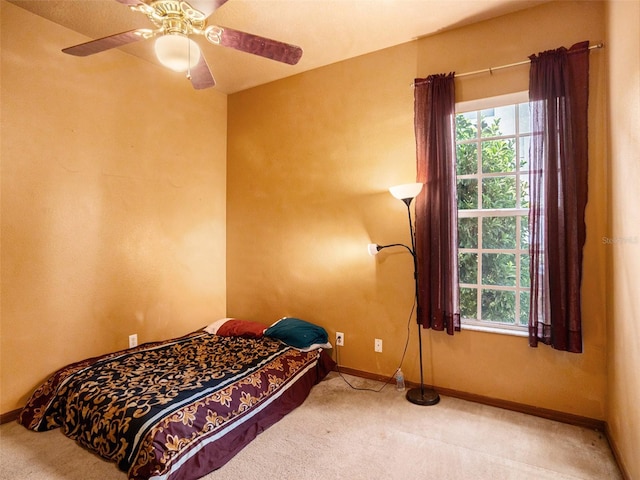 bedroom featuring carpet, ceiling fan, and a textured ceiling