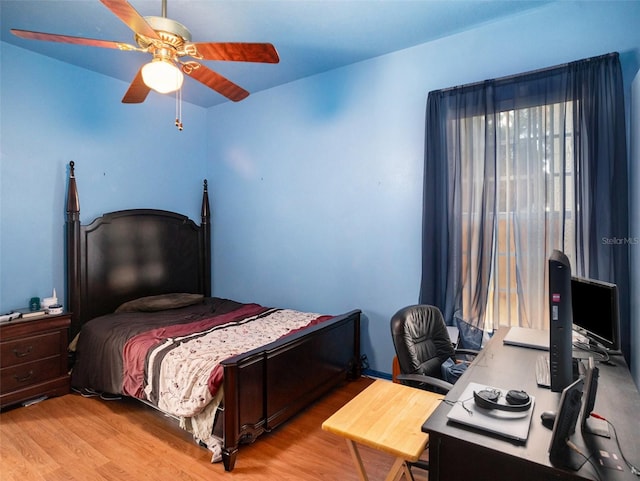 bedroom with light hardwood / wood-style flooring and ceiling fan