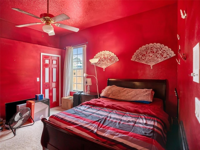 bedroom featuring carpet, a textured ceiling, and ceiling fan